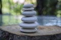 Stone cairn on green blurry background, light pebbles and stones Royalty Free Stock Photo