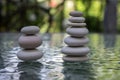 Stone cairn on green blurry background, light pebbles and stones Royalty Free Stock Photo