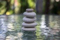 Stone cairn on green blurry background Royalty Free Stock Photo