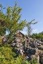 Stone cairn with an old cottage and fruit tree Royalty Free Stock Photo
