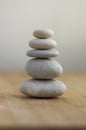 Stone cairn on striped grey white background, five stones tower, simple poise stones, simplicity harmony and balance Royalty Free Stock Photo