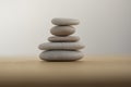 Stone cairn on striped grey white background, five stones tower, simple poise stones, simplicity harmony and balance Royalty Free Stock Photo