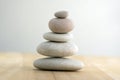 Stone cairn on striped grey white background, five stones tower, simple poise stones, simplicity harmony and balance, rock zen Royalty Free Stock Photo