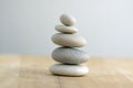 Stone cairn on striped grey white background, five stones tower, simple poise stones, simplicity harmony and balance, rock zen Royalty Free Stock Photo