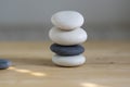 Stone cairn on wood background, stones tower, simple poise stones, simplicity harmony and balance, black and white pebbles Royalty Free Stock Photo