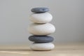 Stone cairn on wood background, stones tower, simple poise stones, simplicity harmony and balance, black and white pebbles Royalty Free Stock Photo