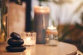 Stone, candle and spa with a still life objects on a table in a wellness center for aromatherapy to relax. Background Royalty Free Stock Photo