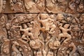 Stone carved bas-relief of Banteay Srei temple in Angkor Wat, Cambodia. Human figures and floral ornament bas-relief. Royalty Free Stock Photo