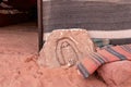 A stone carved Bedouin icon lies near the entrance to a campsite in the endless sandy red desert of Wadi Rum near Amman in Jordan Royalty Free Stock Photo