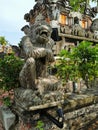 A stone-carved figure of a monkey at a balinese hindu temple on Bali island in Indonesia