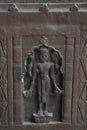 Stone carving art with Hindu deity figure on the pillar of ancient architecture of India