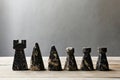 Stone chess pieces on wooden surface with simple background Royalty Free Stock Photo