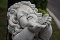 Stone children statue play with the rain Royalty Free Stock Photo