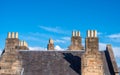 Stone chimney stacks with yellow pots