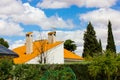 Stone chimneys on rooftops with orange shingles against sky clouds Country house Royalty Free Stock Photo