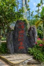 The stone with chinese characters in the tropical forest in Yanoda Park, Sanya city. Hainan island, China