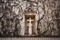 A stone Christian cross set in an alcove in a wall in a chapel Royalty Free Stock Photo