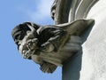 Stone church gargoyles. Head of religious.