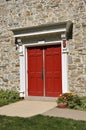 Stone church and red doors Royalty Free Stock Photo