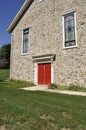 Stone church with red doors Royalty Free Stock Photo