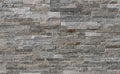 Stone cladding wall made of striped stacked bricks of gray and brown rocks. Panels for exterior Royalty Free Stock Photo