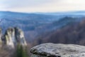 stone cliff podium in foreground and blurred mountain background in background Royalty Free Stock Photo