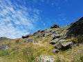 Stone cliffs rise against the blue sky