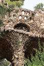 Stone colonnade in Park Guell, Barcelona, designed to resemble tree trunks, showcasing the genius of Antonio Gaudi