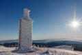 Stone column with height quota 1603 m in snezka, mountain on the border between Czech Republic and Poland, winter morning
