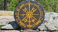Stone compass outdoors, runes, forest background, tourism Royalty Free Stock Photo