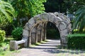 Stone corridor archway in garden green plant