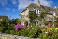 Stone cottage and colourful garden in the village of Kimmeridge in Dorset, England.