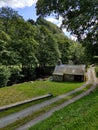 Stone cottage down winding lane besides a river in Wales Royalty Free Stock Photo