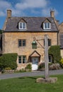 Stone cottage overlooking the village green in the unspoilt picturesque Cotswold village of Stanton in Gloucestershire UK. Royalty Free Stock Photo