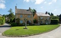 Stone cottages overlooking the village green in the unspoilt picturesque Cotswold village of Stanton in Gloucestershire UK. Royalty Free Stock Photo