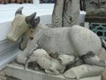 Stone cow feeding a calf doll