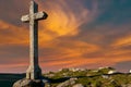Stone cross against beautiful sunset; copy space concept belief Royalty Free Stock Photo