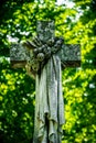 Stone cross, an ancient tombstone in the Catholic cemetery Royalty Free Stock Photo