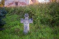 Stone cross with the carved face of the Savior near the Church of Tikhon Zadonsky in the village of Korotsko Royalty Free Stock Photo