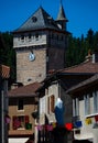 Stone cross and Flowers ,in the medieval town of Malzieu , lozere France .a stage in the way of compostelle a long distance walk