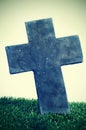 Stone cross of a grave in a cemetery Royalty Free Stock Photo