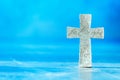 Stone cross with inscription Believe on blue background, Copy space. Christian backdrop. Biblical faith, gospel Royalty Free Stock Photo