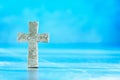 Stone cross with inscription Believe on blue background, Copy space. Christian backdrop. Biblical faith, gospel Royalty Free Stock Photo