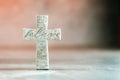 Stone cross with inscription Believe on grey background, Copy space. Christian backdrop. Biblical faith, gospel Royalty Free Stock Photo