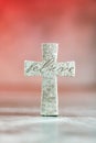Stone cross with inscription Believe on red background, Copy space. Christian backdrop. Biblical faith, gospel Royalty Free Stock Photo
