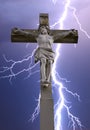 Stone cross with Jesus and sky with lightning Royalty Free Stock Photo