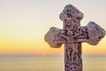 Stone cross with Jesus on it on sundown Royalty Free Stock Photo