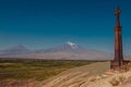 Stone cross khachkar on hill of Khor Virap Monastery. Mountain Ararat on background. Exploring Armenia. Tourism and travel concept Royalty Free Stock Photo