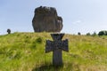 Stone cross on medieval Cossack grave against the single rock