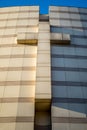 A stone cross on the outer wall of a Christian church